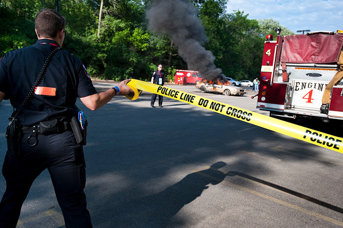 Members of the University Police Department work with the Madison Fire department and other emergency personnel to respond to a mock car explosion and fire during a training drill.