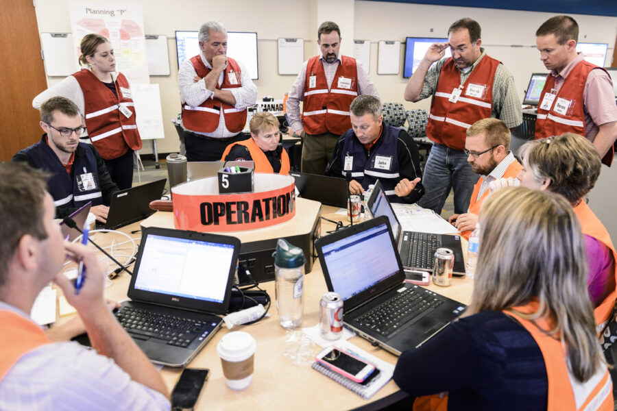 Members of the operations team meet as university leaders, staff and emergency management personnel reported to an Emergency Operation Center (EOC).